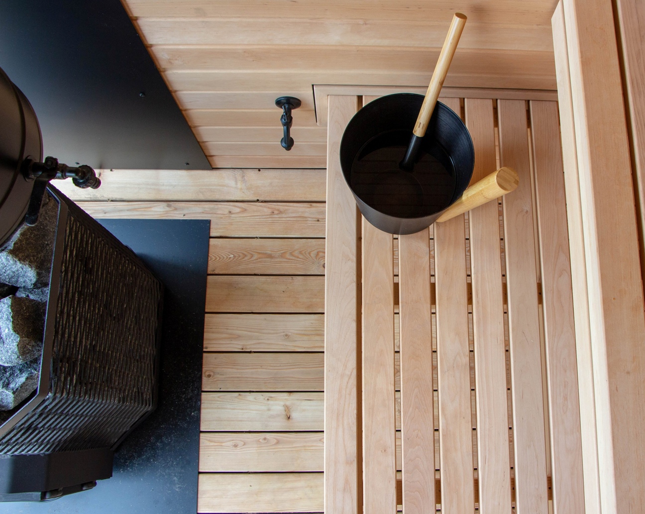Timber benches and panoramic glazing inside an Inari sauna